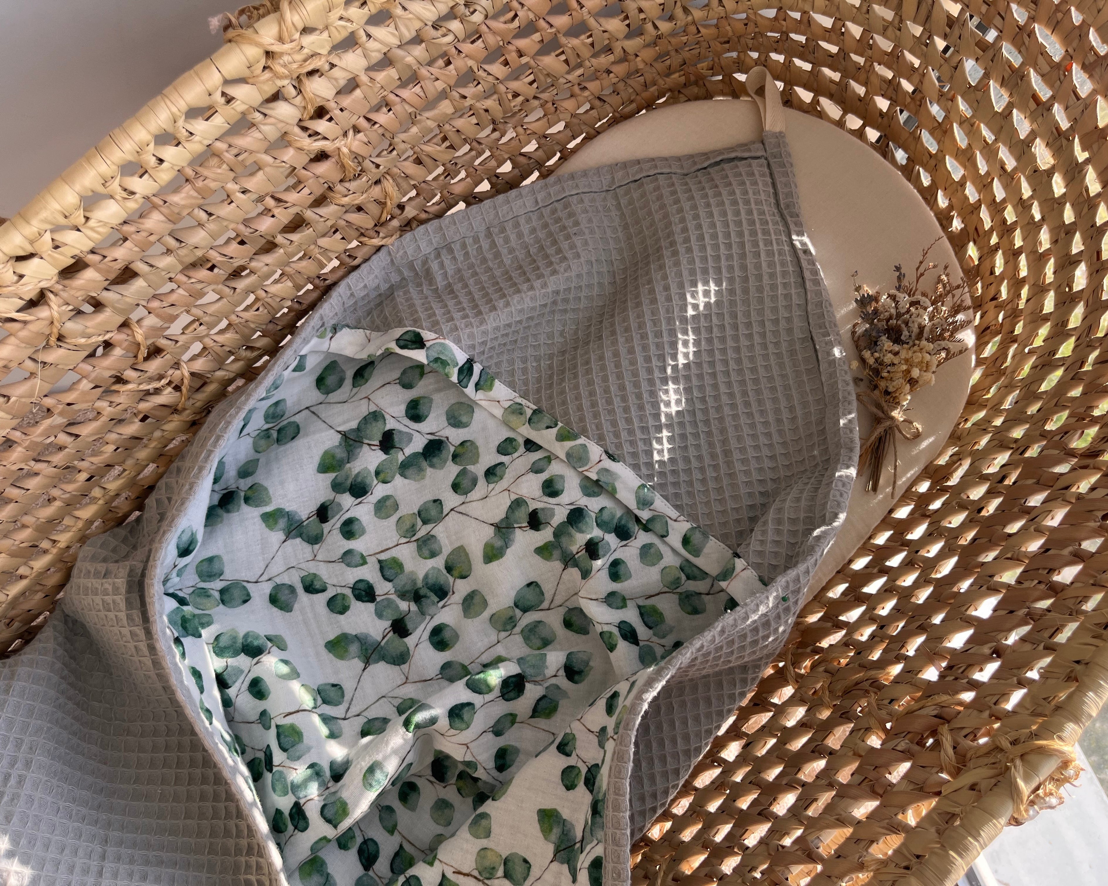 Grey hooded baby bath towel with eucalyptus print muslin