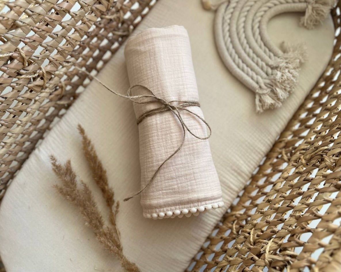 neutral muslin swaddle blanket with pom pom personalized with baby name
