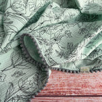 Cotton muslin Pom Pom swaddle blanket - Mint with black flowers