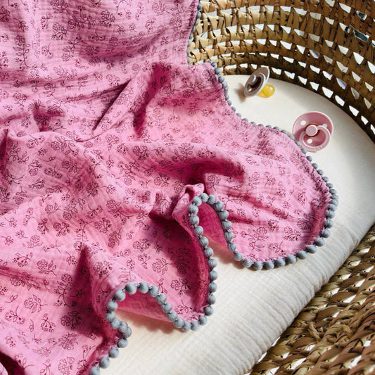 muslin swaddle blanket with pom pom pink flowers