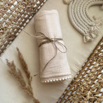 neutral muslin swaddle blanket with pom pom personalized with baby name