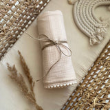 neutral muslin swaddle blanket with pom pom personalized with baby name