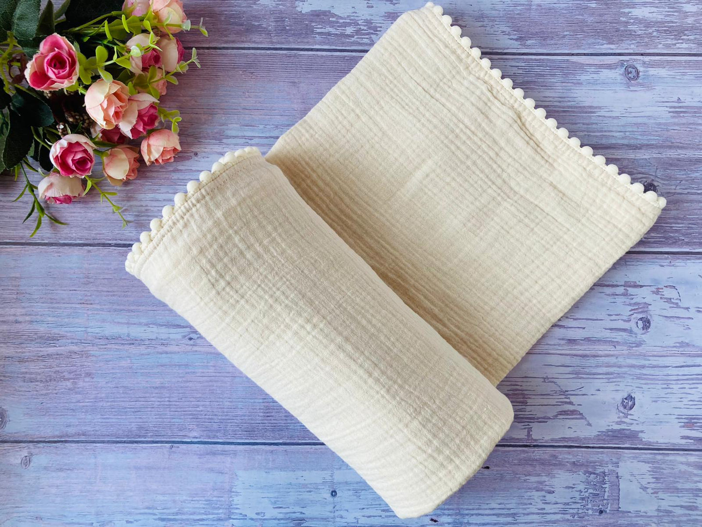 Solid muslin baby swaddle blanket in cream