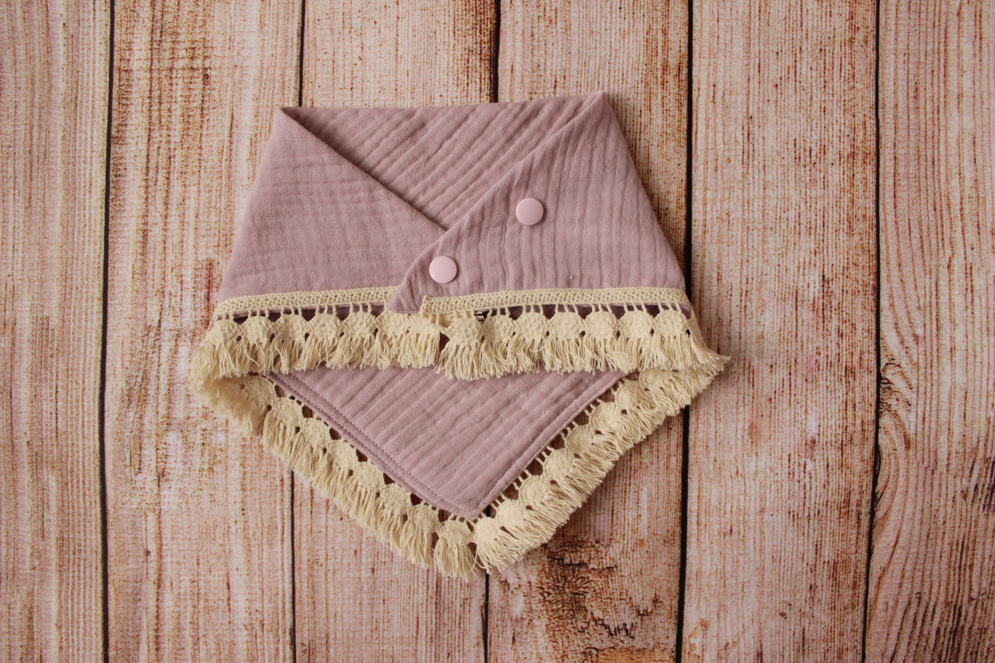 Boho baby bib with a cotton fringe trim - dusty pink