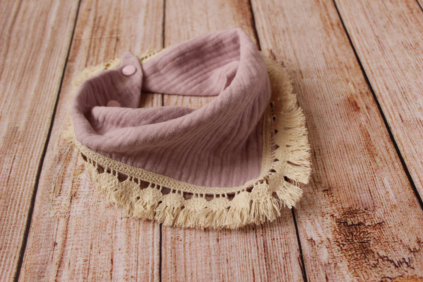 Boho baby bib with a cotton fringe trim - dusty pink