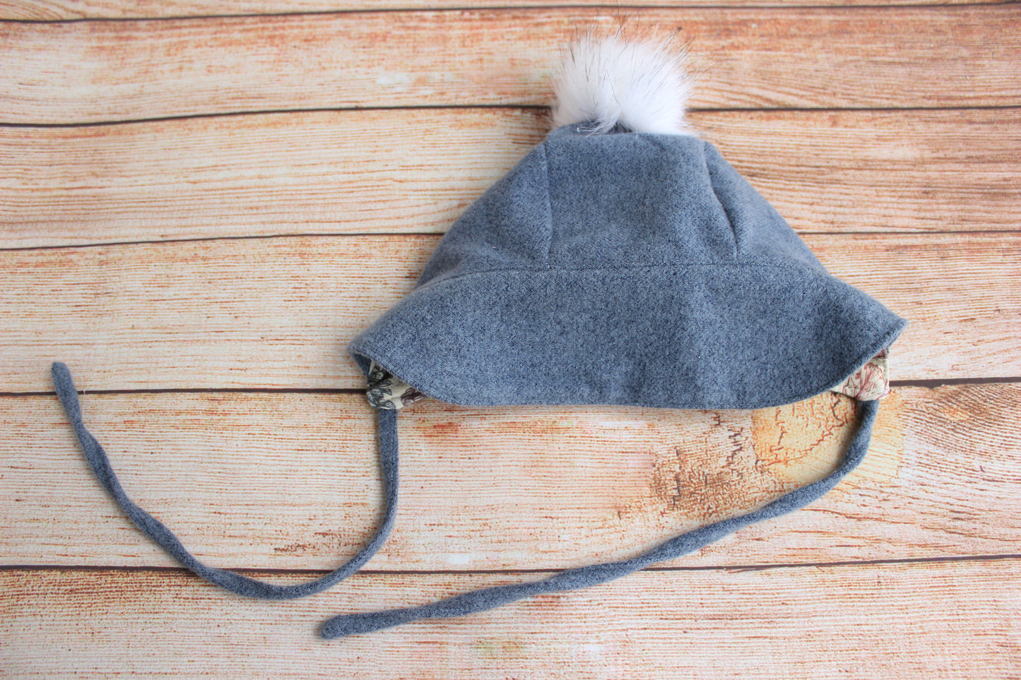 Brimmed Wool Baby bonnet Blue grey with a white pompon